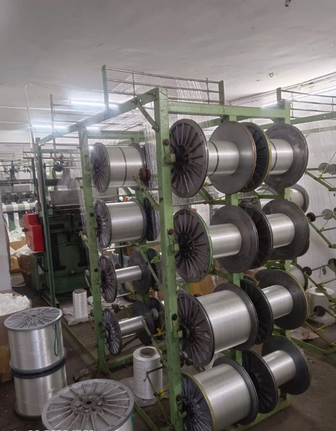 Yarn creel setup used for narrow fabric weaving in textile manufacturing unit