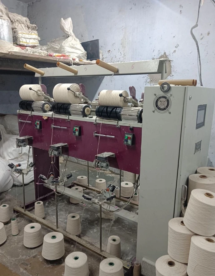 Yarn winding machine used for winding and preparing yarn for textile production